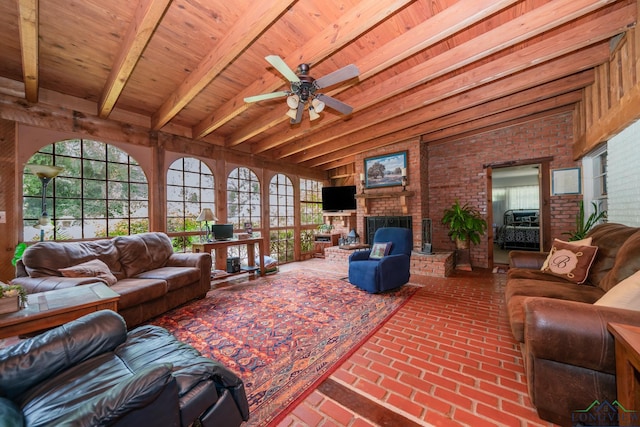 living room with a brick fireplace, wood ceiling, beamed ceiling, and brick wall