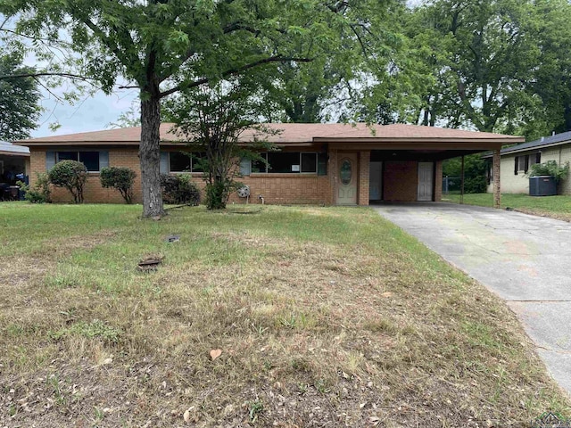 ranch-style home featuring a front lawn, cooling unit, concrete driveway, a carport, and brick siding