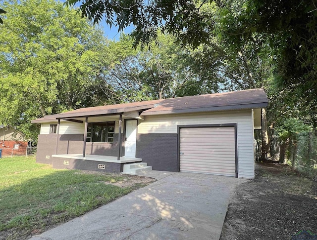 view of front of house with a porch, a garage, and a front lawn