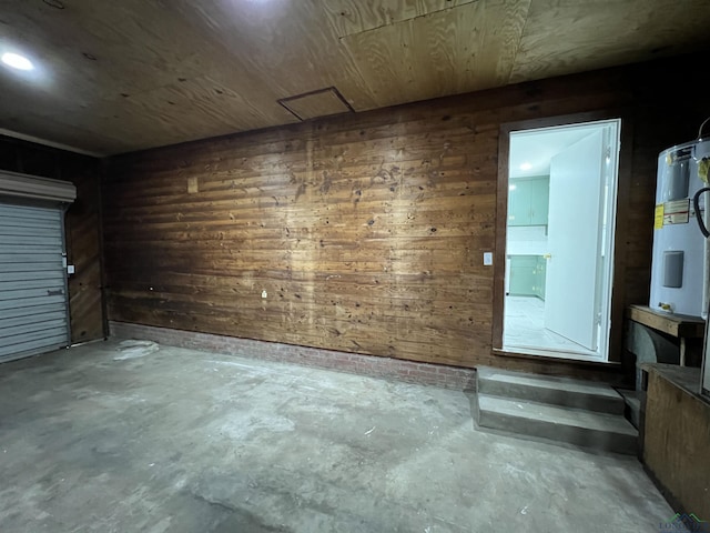 spare room featuring wood walls, concrete floors, and wood ceiling