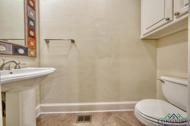 521 Hideaway Ln, Central, Hideaway, TX 75771 - half bathroom with tile patterned flooring, toilet, a sink, visible vents, and baseboards