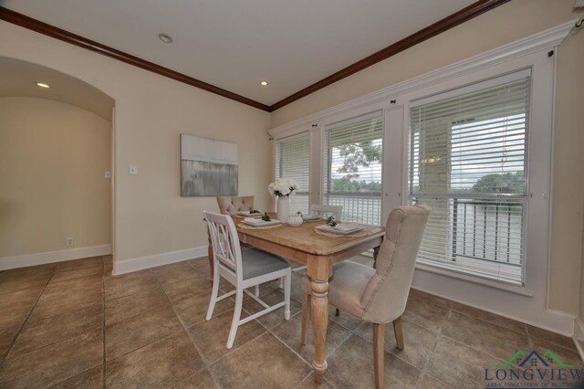 521 Hideaway Ln, Central, Hideaway, TX 75771 - dining area featuring arched walkways, recessed lighting, baseboards, tile patterned floors, and crown molding