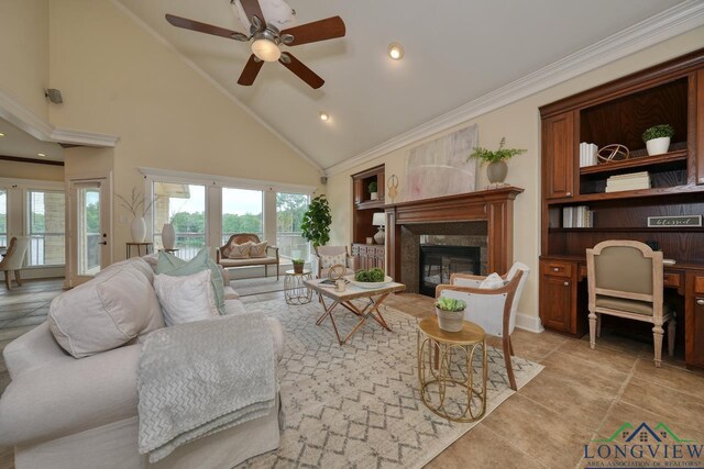 521 Hideaway Ln, Central, Hideaway, TX 75771 - living area featuring high vaulted ceiling, ornamental molding, a high end fireplace, and a wealth of natural light