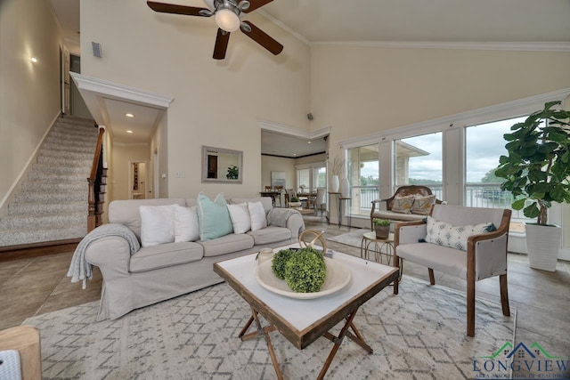 521 Hideaway Ln, Central, Hideaway, TX 75771 - tiled living room featuring a ceiling fan, stairs, a high ceiling, and crown molding