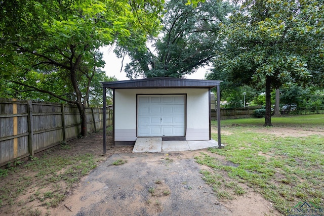 garage featuring a lawn