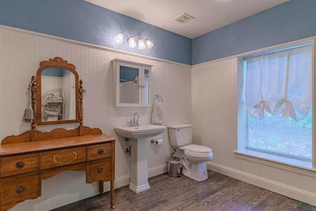 bathroom with wood-type flooring and toilet