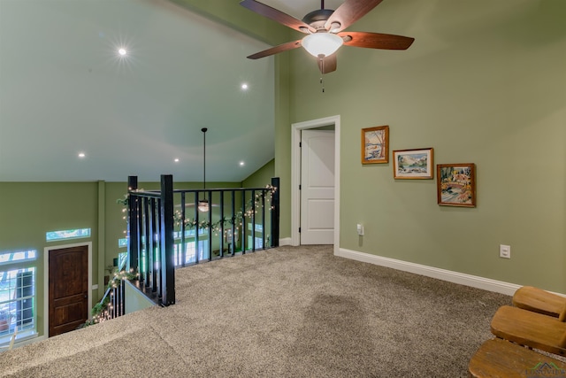 carpeted spare room with high vaulted ceiling and ceiling fan