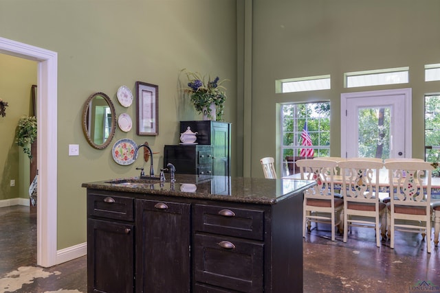 bar featuring sink and dark stone counters