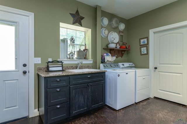 washroom with sink, washer and dryer, and plenty of natural light