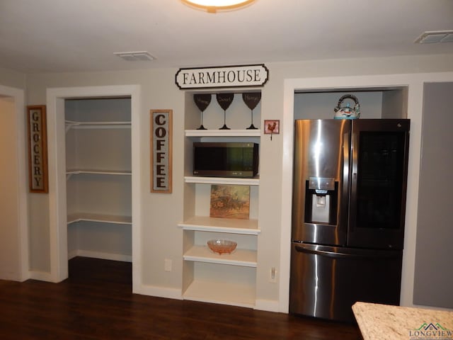 kitchen featuring stainless steel refrigerator with ice dispenser and dark hardwood / wood-style flooring