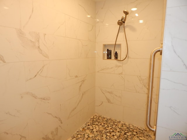 bathroom featuring a shower with door