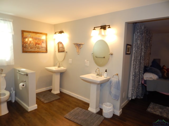 bathroom with hardwood / wood-style flooring, sink, and toilet