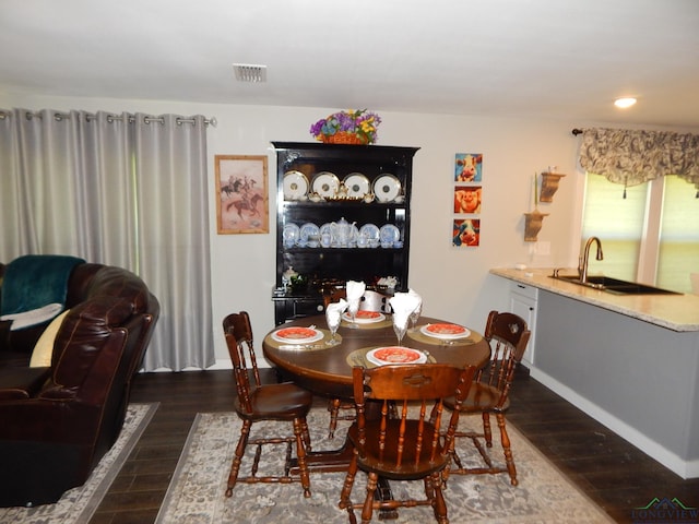 dining room featuring dark hardwood / wood-style floors and sink