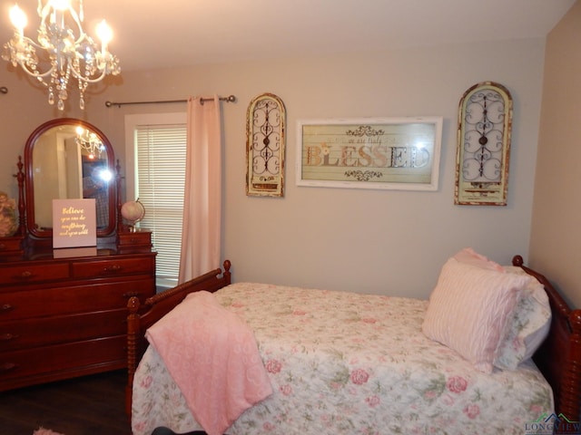 bedroom featuring dark hardwood / wood-style flooring and an inviting chandelier