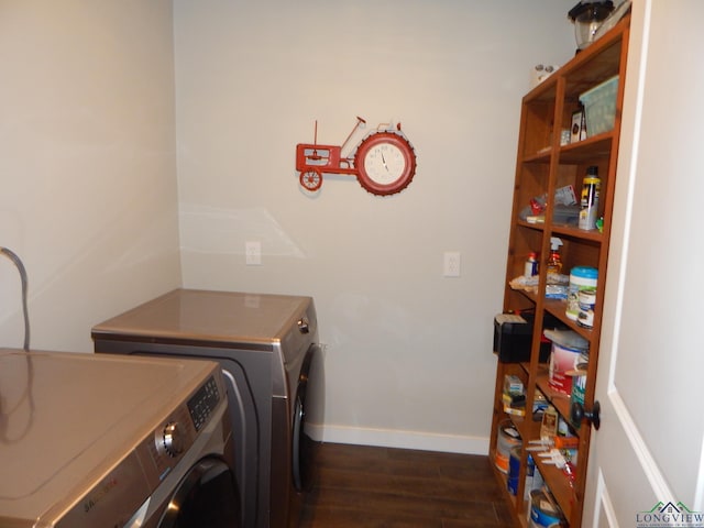 laundry room with independent washer and dryer and dark wood-type flooring