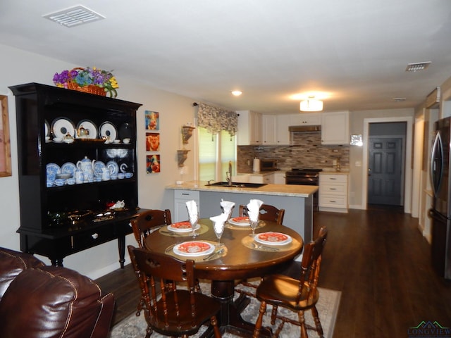 dining area featuring dark hardwood / wood-style flooring and sink