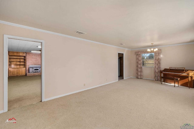 unfurnished room featuring built in shelves, crown molding, carpet floors, a chandelier, and a fireplace