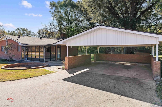 ranch-style home with a sunroom and a carport