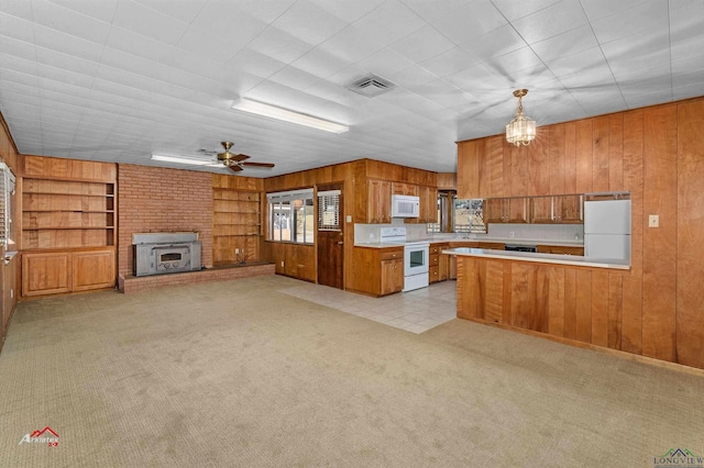 kitchen with built in shelves, ceiling fan, kitchen peninsula, decorative light fixtures, and white appliances