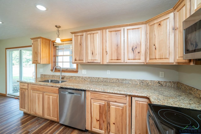 kitchen featuring sink, dark hardwood / wood-style floors, decorative light fixtures, light stone counters, and stainless steel appliances