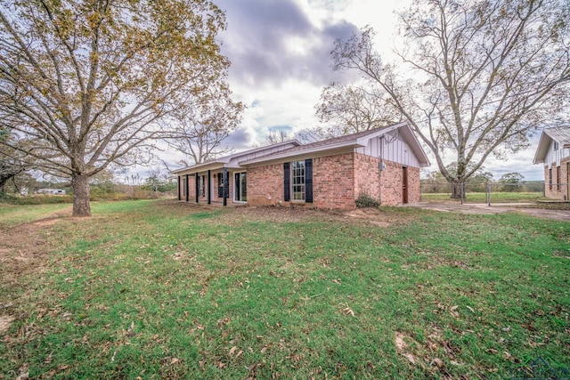 rear view of house with a lawn