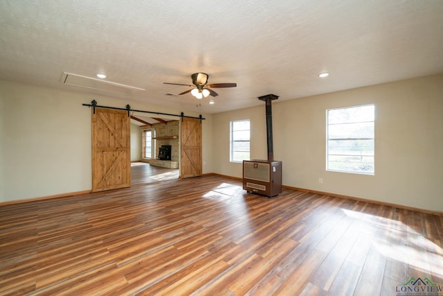 unfurnished living room featuring hardwood / wood-style floors, a textured ceiling, and ceiling fan