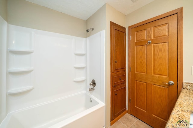 bathroom featuring a textured ceiling, tile patterned flooring, vanity, and  shower combination