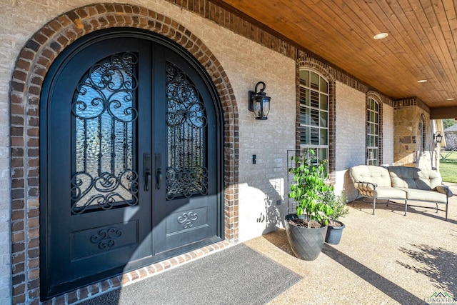 view of exterior entry featuring french doors