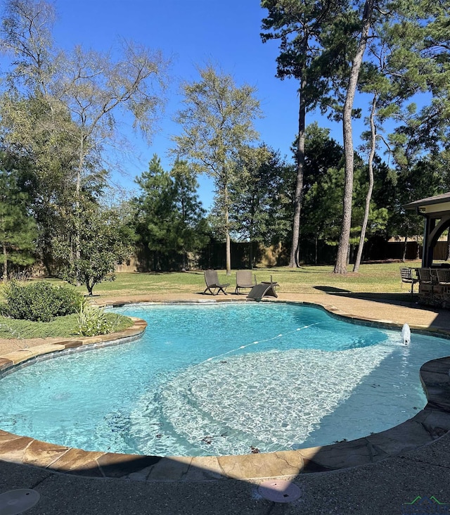 view of pool with a lawn