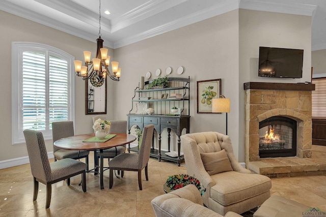 tiled dining area featuring a tray ceiling, crown molding, a stone fireplace, and an inviting chandelier