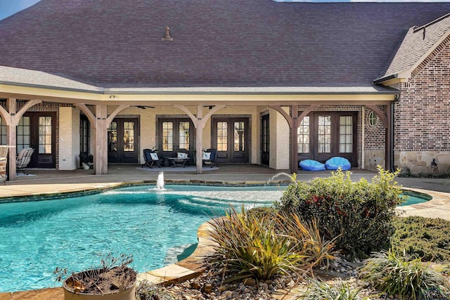 view of pool featuring french doors and a patio area