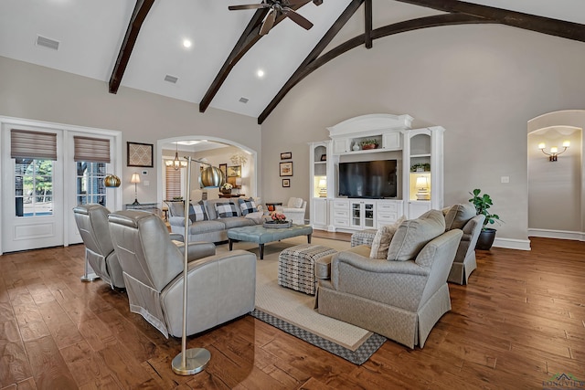 living room featuring ceiling fan with notable chandelier, wood-type flooring, and high vaulted ceiling