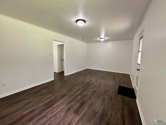 1505 E Birdsong, Longview, TX 75602 - spare room with dark wood-style flooring and baseboards