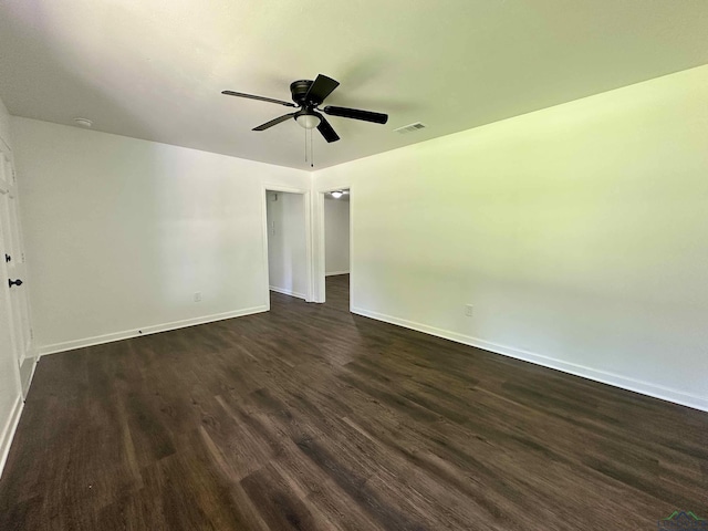 1505 E Birdsong, Longview, TX 75602 - spare room with baseboards, dark wood finished floors, and a ceiling fan