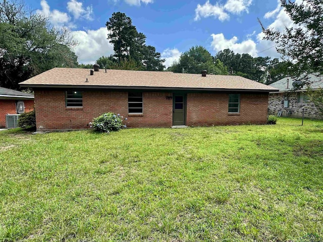 1505 E Birdsong, Longview, TX 75602 - back of property featuring brick siding, cooling unit, and roof with shingles
