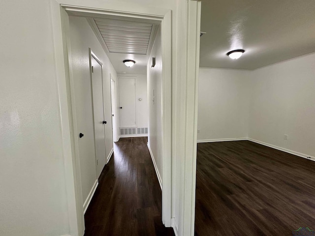 1505 E Birdsong, Longview, TX 75602 - corridor with dark wood-style floors, baseboards, and attic access