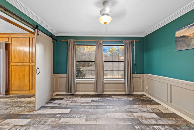 5 Amy Scott Ct, Longview, TX 75605 - empty room featuring a barn door, a ceiling fan, wood finished floors, wainscoting, and ornamental molding