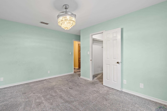 5 Amy Scott Ct, Longview, TX 75605 - unfurnished bedroom featuring a chandelier, carpet flooring, and a walk in closet