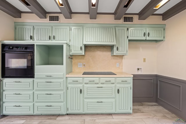 5 Amy Scott Ct, Longview, TX 75605 - kitchen with green cabinets, black appliances, custom range hood, a wainscoted wall, and light countertops