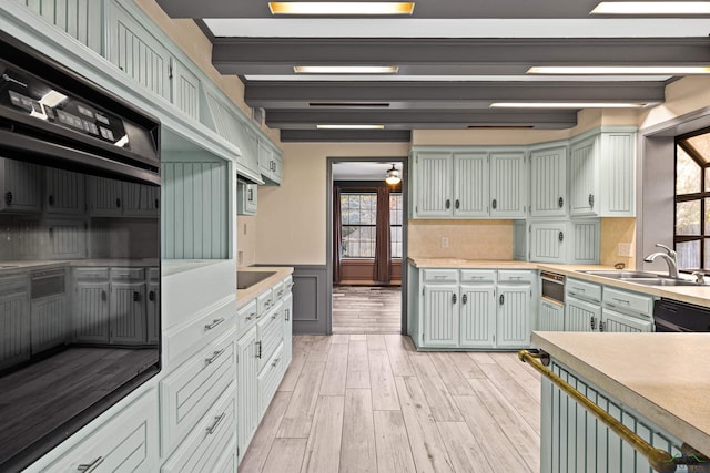 5 Amy Scott Ct, Longview, TX 75605 - kitchen featuring healthy amount of natural light, light wood-style floors, light countertops, dishwasher, and wainscoting