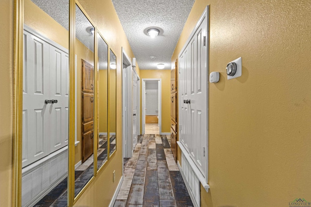 5 Amy Scott Ct, Longview, TX 75605 - hall featuring a textured ceiling and dark wood-type flooring