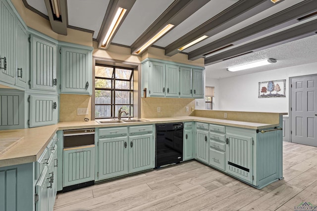 5 Amy Scott Ct, Longview, TX 75605 - kitchen with black dishwasher, a peninsula, light wood-style flooring, light countertops, and tasteful backsplash