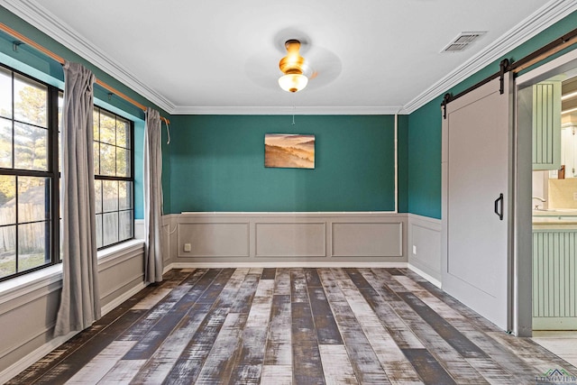 5 Amy Scott Ct, Longview, TX 75605 - spare room with a barn door, ceiling fan, wood-type flooring, ornamental molding, and a wainscoted wall