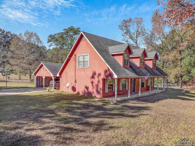 view of side of property featuring a patio and a lawn