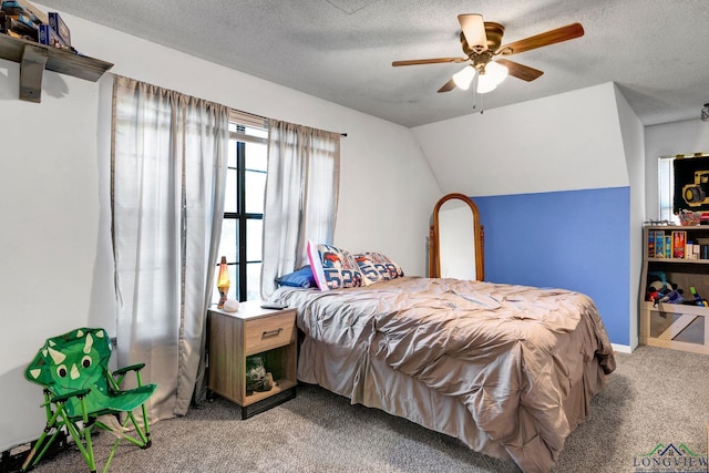 carpeted bedroom featuring ceiling fan, a textured ceiling, and vaulted ceiling