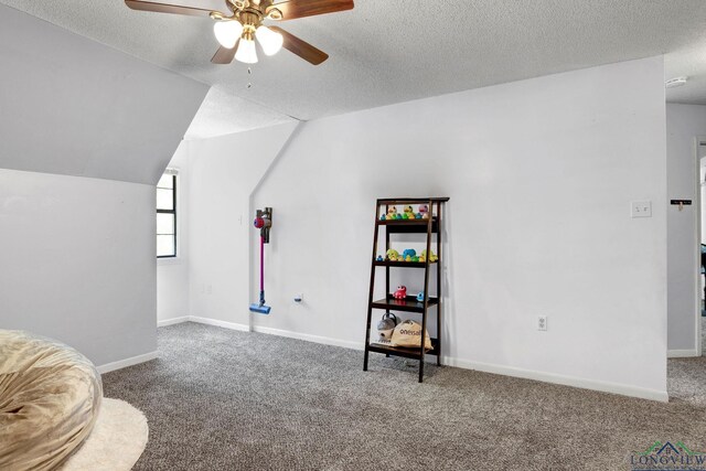 living area with a textured ceiling, carpet floors, ceiling fan, and lofted ceiling