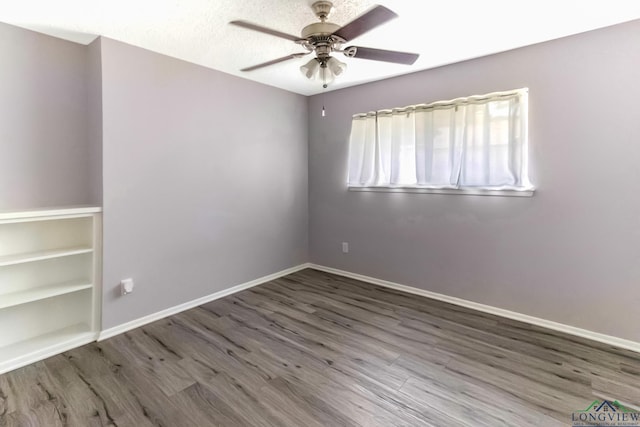 2104 Mccann Rd, Longview, TX 75601 - empty room featuring a ceiling fan and wood finished floors