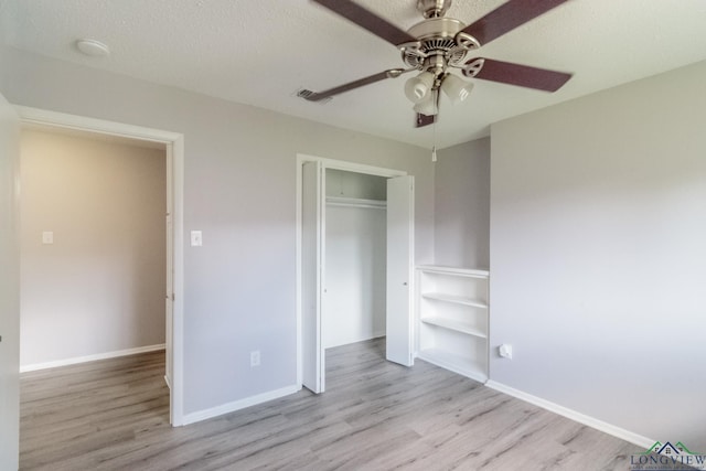 2104 Mccann Rd, Longview, TX 75601 - unfurnished bedroom with wood finished floors, a closet, and a ceiling fan