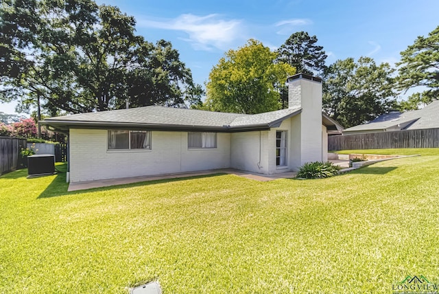 2104 Mccann Rd, Longview, TX 75601 - back of house featuring a chimney, brick siding, and a shingled roof
