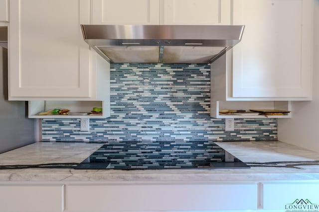 2104 Mccann Rd, Longview, TX 75601 - kitchen featuring tasteful backsplash, range hood, and white cabinetry